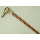 A malacca cane, with silver collar and bone carved handle in the shape of an elephant's head,