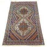 A Shirvan hand knotted rug with two central medallions, approx 140 knots per square inch,