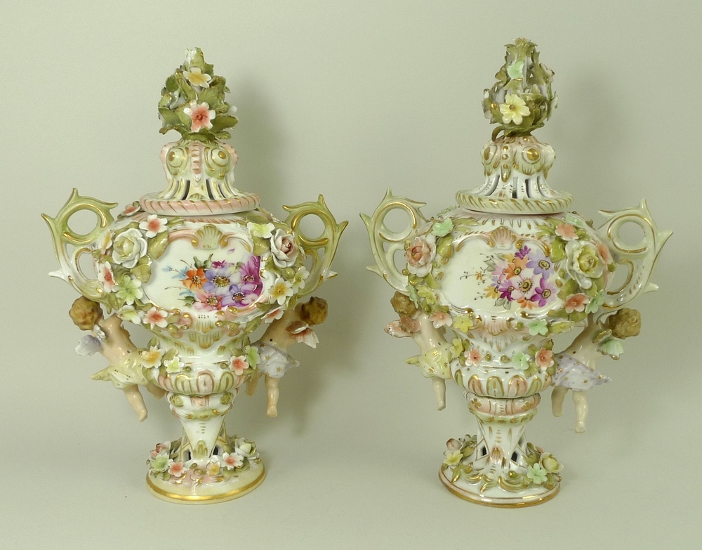 A pair of Sitzendorf lidded vases, decorated in high relief with flowers and pair of putti, - Image 3 of 8