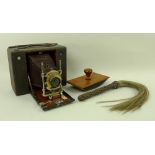 An 1887 Eastman Kodak bellows folding camera, an African plaited leather and horsehair fly whisk,