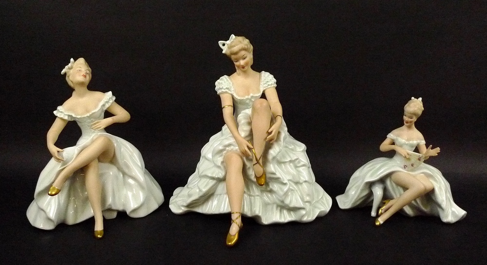 A group of three Wallendorf porcelain figures, comprising a seated ballerina tying her shoe ribbon,