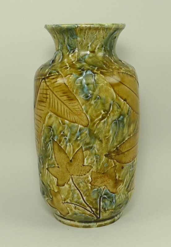 A ceramic vase of ovoid form, with moulded leaf design, in Royal Doulton style,