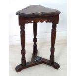 A Victorian oak occasional table, with trefoil surface, three carved legs and stretcher base, 36.