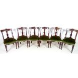 A set of six Victorian Aesthetic mahogany dining chairs, bowed backs with carved decoration,