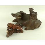 A late 19th or early 20th century Chinese carving of a boy riding an ox or water buffalo,