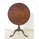 A George III mahogany tilt top circular occasional table, turned column, tripod base,