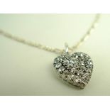 A heart shaped pendant set with thirty one old cut diamonds, silver set onto 18ct gold,