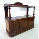 An early Victorian mahogany buffet, with shaped upstand on an upper tier shelf, carved,