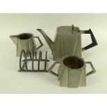 An Art Deco hammered pewter part tea set, comprising teapot, milk jug and sucrier,