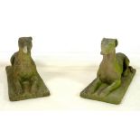 A pair of 19th century carved stone figures, modelled as recumbent greyhounds,