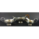 A George V silver three piece tea set, comprising teapot, sugar bowl and milk jug,