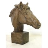 A modern reconstituted plaster sculpture, modelled as a horse's head, on a square plinth base,