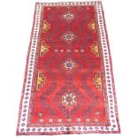 A Baluchi rug with red ground,