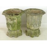 A pair of reconstituted stone garden octagonal urns, on matching eight footed pedestals,