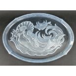 A blue glass platter, reverse engraved with a mermaid, merman, fish, scallop shell and waves,