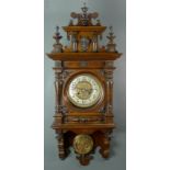 An American stained mahogany and pine cased wall clock, 20th century, with brass face,