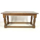 A late 19th century oak refectory table, three plank surface over a chip carved frieze,