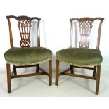 A pair of early George III mahogany dining chairs, with carved and moulded rails,