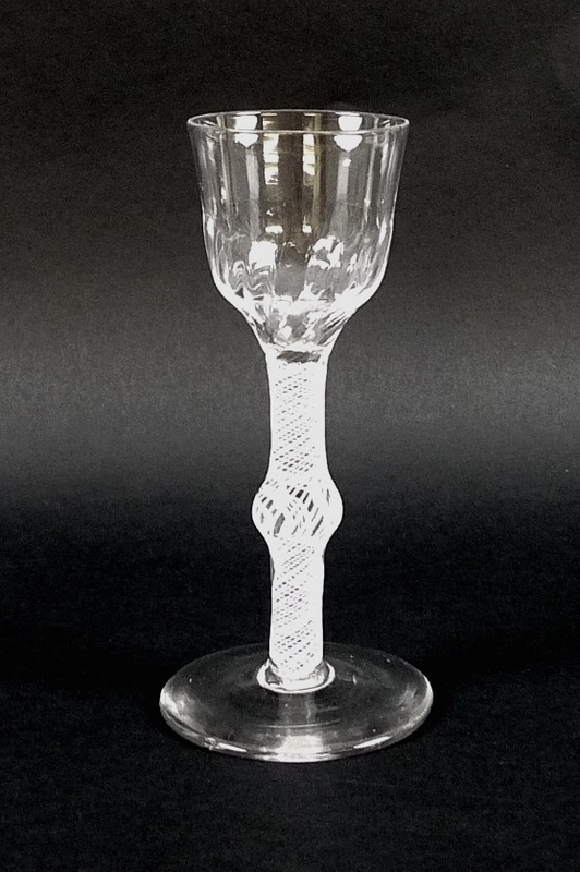 An 18th century opaque air-twist stem and knop drinking glass with soft fluted bucket bowl, English,