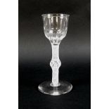 An 18th century opaque air-twist stem and knop drinking glass with soft fluted bucket bowl, English,