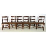 A set of six Georgian mahogany dining chairs, with bar back top rails, rosette carved mid rails,