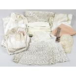 A collection of vintage lace and cotton garments, including two christening gowns, with three caps,