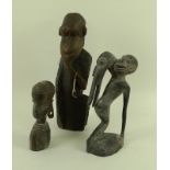 A collection of three carved tribal figures,