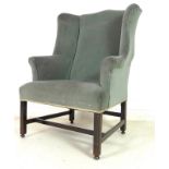 A late Georgian mahogany framed wing armchair, upholstered in blue / grey velvet,