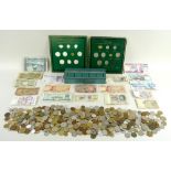 A collection of UK and World coins, eighteen vintage bank notes, and a metal money tin.