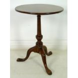 An early Victorian tilt top circular occasional table, turned baluster column,