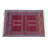 A Persian wool prayer rug, with red ground, geometric pattered decoration in cream and dark blue,