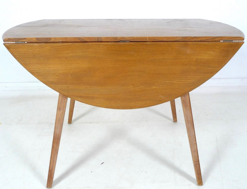 An Ercol dining suite, circa 1960's, comprising circular elm and beech drop leaf dining table, - Image 3 of 10