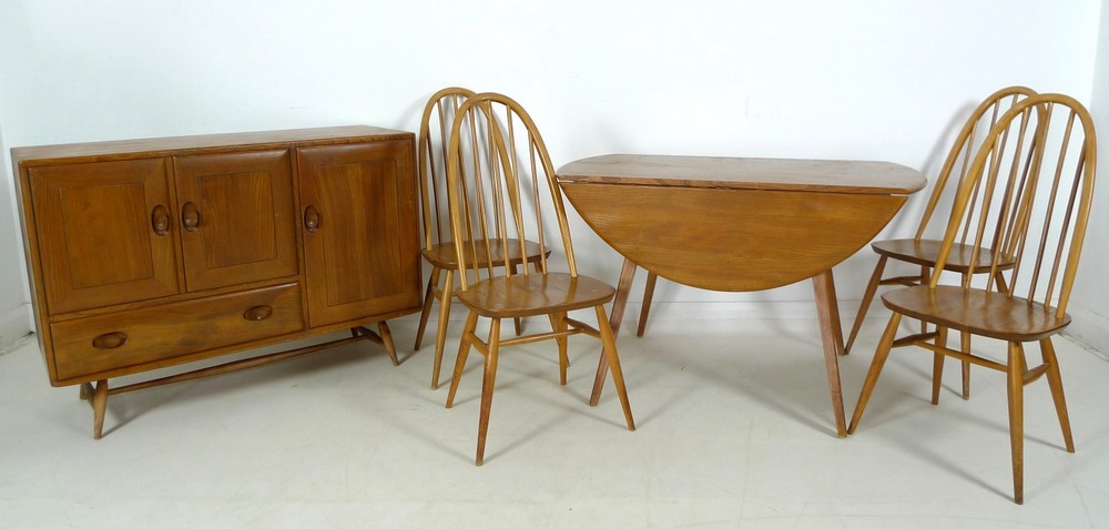 An Ercol dining suite, circa 1960's, comprising circular elm and beech drop leaf dining table,
