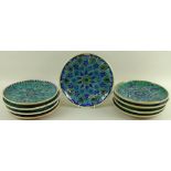 A collection of mid 20th century Iznik style plates, all hand thrown and hand decorated,