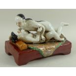 A modern Chinese erotic ceramic sculpture, depicting two lovers in the throes of passion,