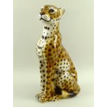 An Italian ceramic model of a seated cheetah, base incised Italy, possibly by Intrada,