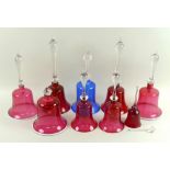 A collection of Victorian and later Bohemian ruby flashed bells, several with wrythen detailing,