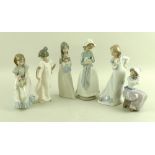 A group of Nao figurines, comprising a standing girl in a sweeping dress with butterfly, 23.