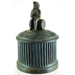 CAST IRON TOBACCO JAR. 6ins tall to top of lid with man on barrel finial, ribbed main body. (7/10)