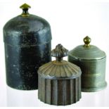 GROUP OF TOBACCO JARS. Tall lead cylindrical jar with brass finial & tamper. Plus cast iron jar,