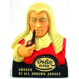 ORLIK PIPES ADVERTISING BUST. 10ins tall, formed as judge smoking pipe in white, red & brown ORLIK