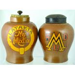 PAIR OF SHOP DISPLAY TOBACCO JARS. One 11ins tall to top of cork lid with brass finial, brown