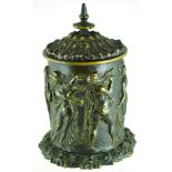 BRASS TOBACCO JAR. 8.5ins tall to top of cover, Grecian style figures in relief all around.