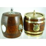 PAIR OF TREEN TOBACCO JARS. Oak cylindrical jar, porcelain lined with tamper. EPNS lid & bands,