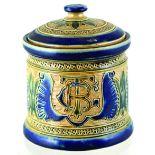 FULHAM POTTERY TOBACCO JAR. 5ins tall, blue & green raised design on buff ground. The Pottery Fulham