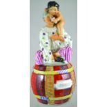 ENGLISH VICTORIAN STAFFORDSHIRE POTTERY TOBACCO JAR & COVER. In the form of a seated Pierrot & Putti