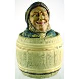 FISHERMAN TOBACCO JAR. 7.75ins tall, fishermanâ€™s head lid atop barrel in matt browns colouring.