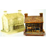 PAIR OF COTTAGE SHAPE TOBACCO JARS. One treacle glazed thatched roof cottage 6ins tall plus matt