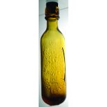 AMBER GLASS ROUND BOTTOMED CYLINDER. 9.5ins long to top of screw stopper. Embossed THIS BOTTLE/