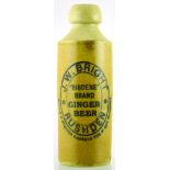 RUSHDEN GINGER BEER BOTTLE. 7.25ins tall, st. bottom tan glaze, black transfer J.W. BRIGHT/ RUSHDEN/